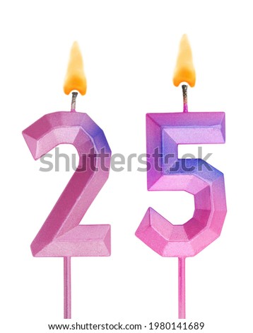 Pink and blue burning birthday candles isolated on white background, number 25