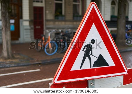 The traffic sign warns of works and reconstruction of roads                               