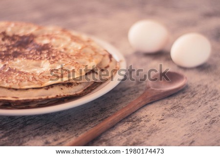 Plate with homemade pancakes. Selective focus. Free space to write. Old wooden table for cooking.