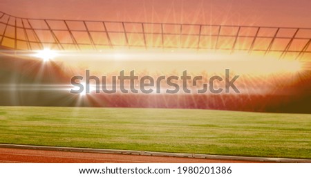 Composition of empty sports stadium with glowing orange spotlights. sport and competition concept digitally generated image.