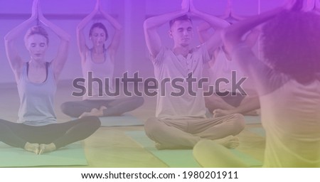 Composition of man and women practicing yoga on purple tinted background. exercise, wellbeing and active lifestyle concept digitally generated image.