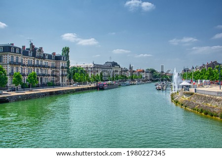 View over the river Meuse, Canal de l'Est, from the Pont Chaussee in the city of Verdun department of Meuse, in the region of Grand Est, France. HDR image Royalty-Free Stock Photo #1980227345