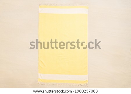 Yellow towel on tropical sand beach. Top and aerial view. Ocean coastline. Drone photo. Background