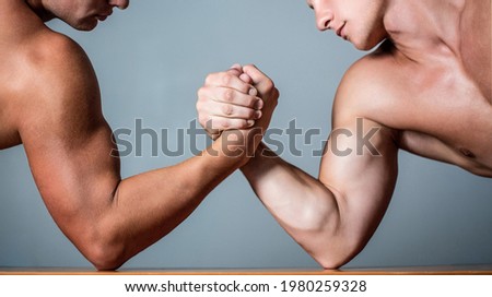 Muscular hand. Clasped arm wrestling. Two men arm wrestling. Rivalry, closeup of male arm wrestling. Two hands. Muscular men measuring forces, arms. Hand wrestling, compete. Hands or arms of man.