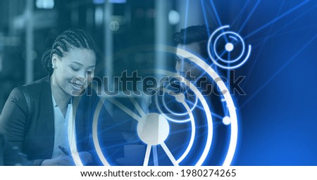 Composition of white circles over diverse group of businesspeople in modern office. global business, finance and networking concept digitally generated image.