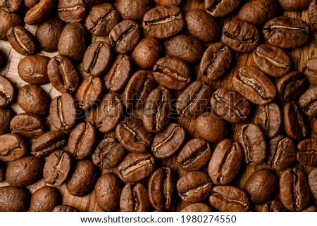 perfect top view of dark roasted coffee beans. Can be used as background. Free space for text. Seamless texture