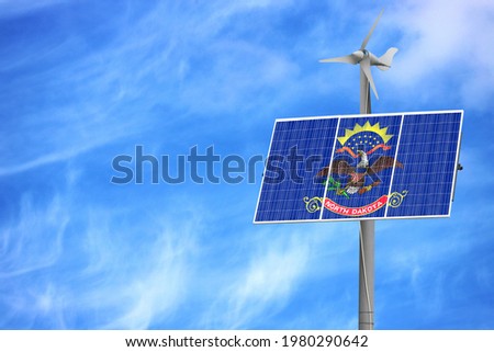 Solar panels against a blue sky with a picture of the flag State of North Dakota