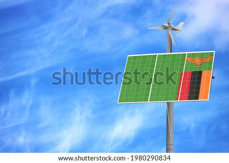 Solar panels against a blue sky with a picture of the flag of Zambia