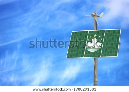 Solar panels against a blue sky with a picture of the flag of Macau