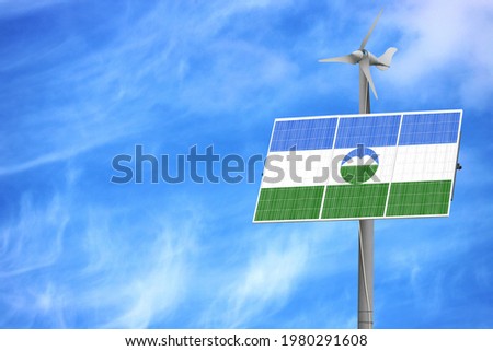 Solar panels against a blue sky with a picture of the flag of Kabardino Balkaria