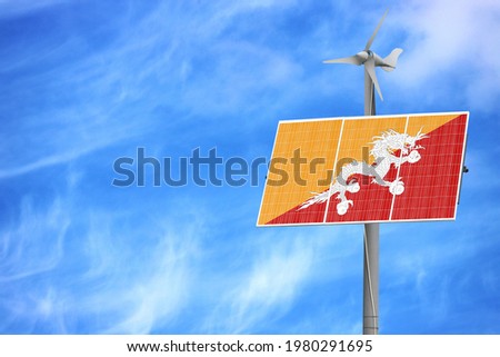 Solar panels against a blue sky with a picture of the flag of Butane