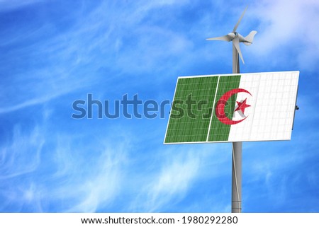 Solar panels against a blue sky with a picture of the flag of Algeria