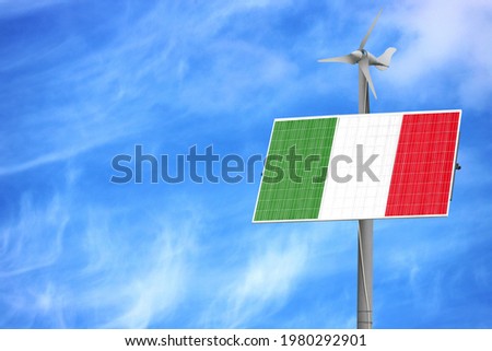 Solar panels against a blue sky with a picture of the flag of Italy