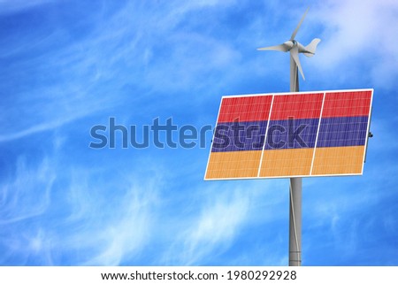 Solar panels against a blue sky with a picture of the flag of Armenia