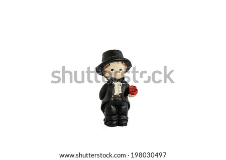Miniature statue of groom with a wedding ring, isolated on white