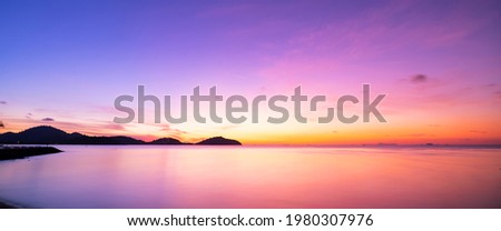 Landscape Long exposure of majestic clouds in the sky sunset or sunrise over sea with reflection in the tropical sea Beautiful cloudscape scenery Amazing light of nature Landscape.. Royalty-Free Stock Photo #1980307976