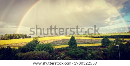 Double rainbow over the meadow.