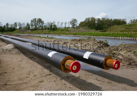Construction of a district heating system for eco friendly homes.
The sustainable heat pipes for eco friendly houses in the Netherlands are photographed at a low angle with nature in the background. Royalty-Free Stock Photo #1980329726
