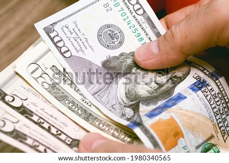Money, US dollar. A woman counting dollar bills. Close up photo. Concept for economy and personal finance.

 Royalty-Free Stock Photo #1980340565