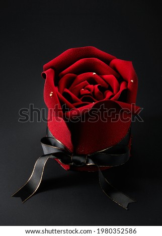 Close-up rose flower shaped cake on dark background