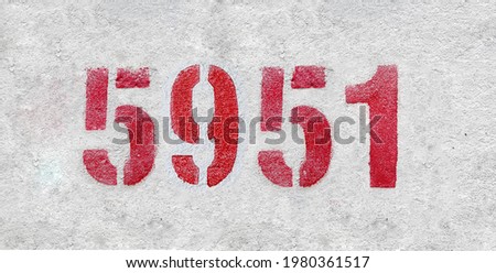 Red Number 5951 on the white wall. Spray paint.
