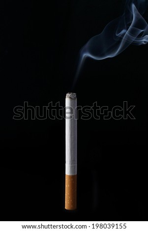 Realistic burning cigarette on black background