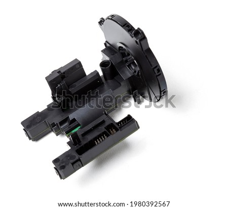  steering angle sensor disassembled on a white isolated background, spare part for car repair or for sale at junk yard.