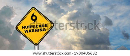hurricane warning sign on cloudy background