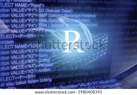 R programming language inscription against laptop computer and code background. Royalty-Free Stock Photo #1980408395