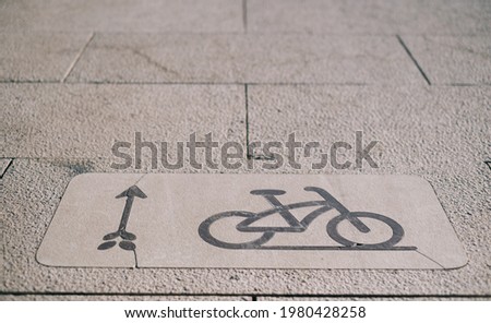 Sign of a bicycle path on the sidewalk.