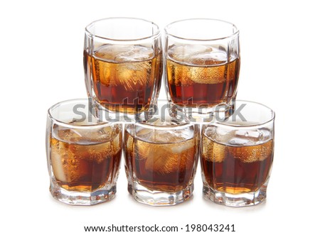 Glass jars with whiskey on a white background