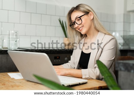 beautiful young woman working at home with laptop	