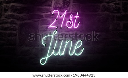 Bright neon sign that says 21st of June on a brick wall background