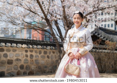 Korean lady in hanbok dress costume smile in an ancient Gyeongbokgung palace in Seoul city, South Korea, this image can use for travel, and tourist Seoul. Royalty-Free Stock Photo #1980453011