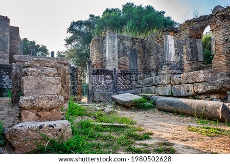 Broken Column remains in the Old city of Olympia in Peloponnes with its ancient monuments, Greece