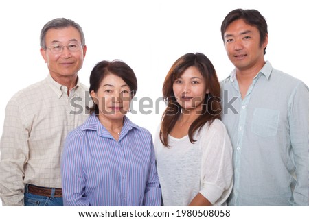 Japanese senior couple and middle-aged couple smiling at the camera