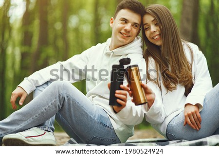 Beautiful couple spend time in a spring forest