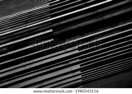 Close-up photo of structural wall of modern building. Abstract futuristic hi-tech architecture. Geometric background with linear pattern, panels, stripes and parallel lines in diagonal composition. Royalty-Free Stock Photo #1980543116