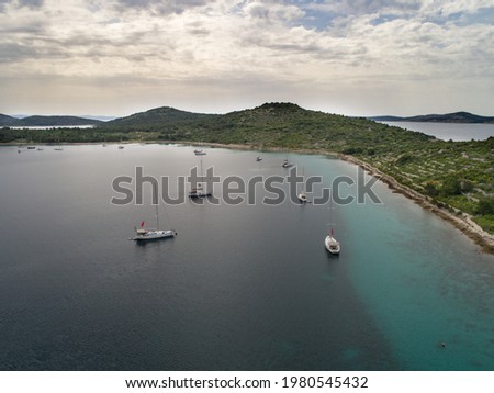 Croatian island with sailing ships from drone view