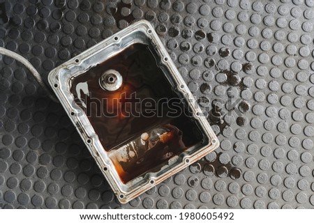 Old used car automatic transmission oil pan. Royalty-Free Stock Photo #1980605492