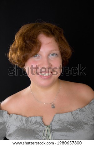 portrait of a smiling girl on a black background