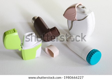 Various inhalers against asthma and allergies on a white background Royalty-Free Stock Photo #1980666227