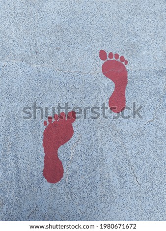 footprints on the asphalt Lapangan Banteng Park during PSBB transition, Jakarta Indonesia. 