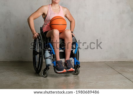 Female athlete in a wheelchair with a basketball