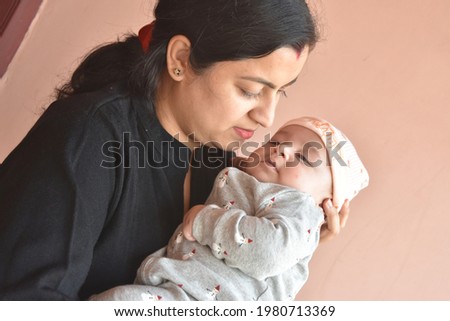 cute newborn Baby in the arms of Mom.