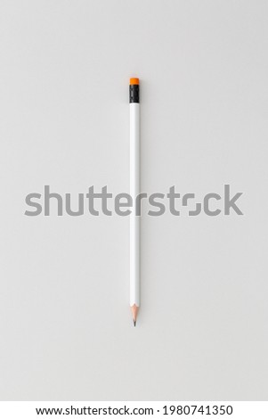 Pencil on grеy background. Top view. Flat lay. Back to school concept.