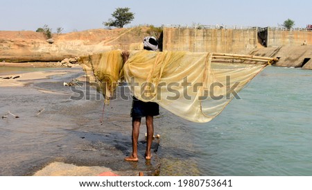 A man going for fishing in River using small Dragnet