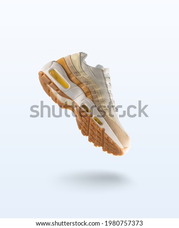 Woman Sneaker on light grey background, woman fashion, sport shoe concept, floating idea, air, product photography Royalty-Free Stock Photo #1980757373