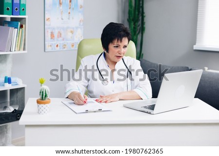 Female doctor talk with patient make telemedicine online webcam video call. Woman therapist videoconferencing on computer in remote telemedicine laptop virtual chat. Telehealth concept. Royalty-Free Stock Photo #1980762365