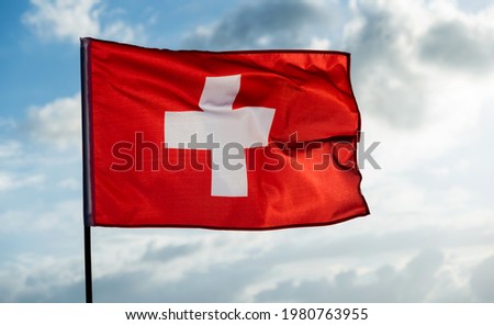 Swiss flag waving against sky